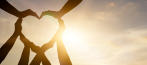 multiple hands forming the shape of a heart