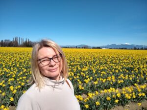 LCSNW Case Manager Nataliya Sereda in a field of daffodils.