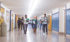 teenagers walking through high school hallway