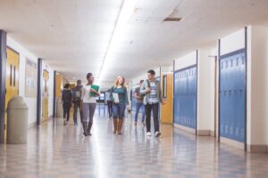 teenagers walking through a school hallway