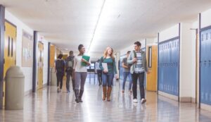 teenagers walking through a high school hallway