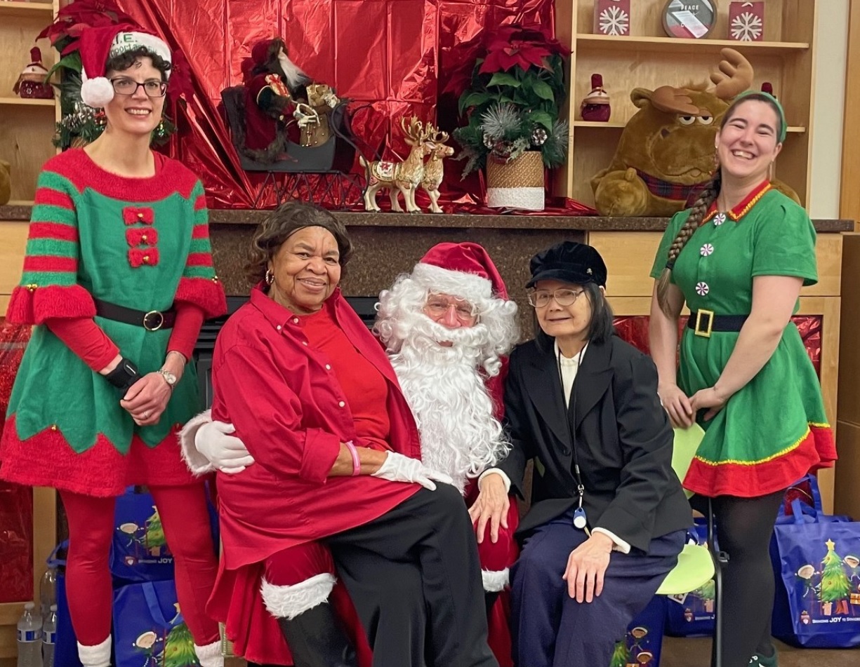 Husband and wife stand facing the Giving Machine vending machines