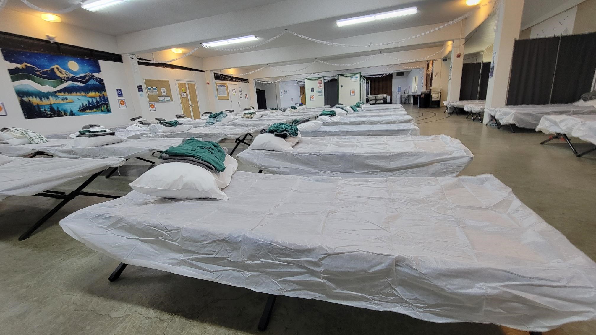 Husband and wife stand facing the Giving Machine vending machines