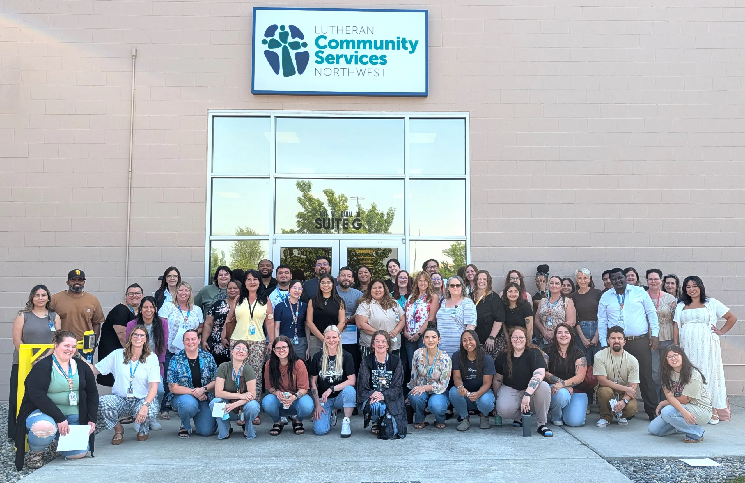 Tri-Cities staff together as a group in front of their Kennewick office
